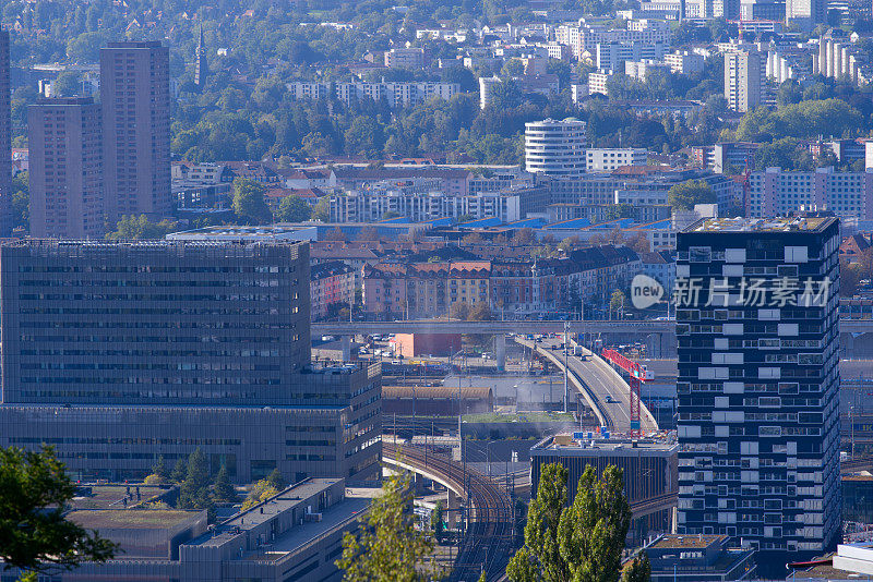 Aerial view of City of Zürich with skyscrapers and urban roads on a sunny late summer day.
